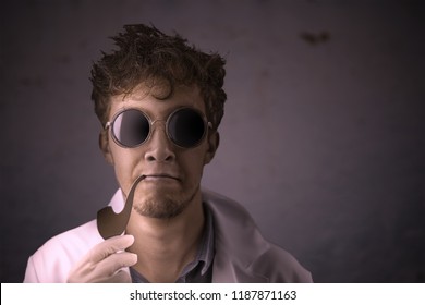 Crazy scientist with a Smoking pipe in a white coat and black sunglasses on a dark old wall background. Halloween cosplay concept with copyspace