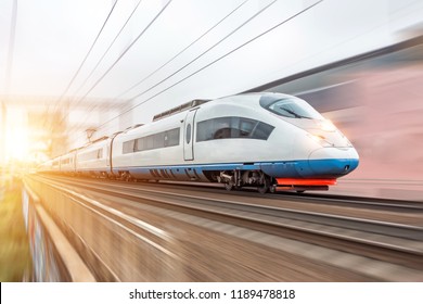 High speed fast train passenger locomotive in motion at the railway station city