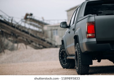 Pickup suv car at the gravel carrier. Back view of truck at the rural road