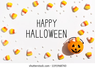 Happy Halloween message with pumpkin overhead view on a solid color