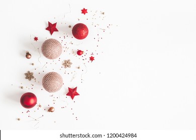 Christmas composition. Christmas red and golden decorations on white background. Flat lay, top view, copy space