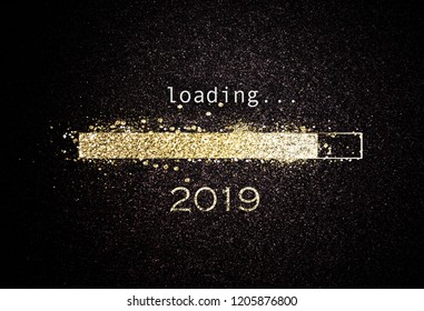 Computer screen with loading bar counting down for New Years Eve 2019 with sparkling glitter and copy space over black