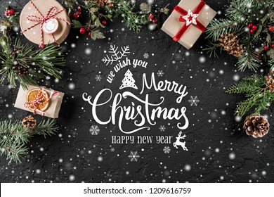 Christmas and New Year Typographical on holiday background with Fir branches, gifts, berries. Xmas and Happy New Year theme, snow. Flat lay, top view