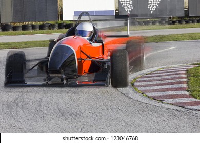 Bolide merah melaju dengan kecepatan tinggi di sirkuit.