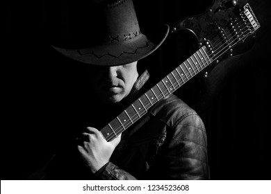 Silhouette of guitar player. Portrait of guitarist . Music concept, guitarist in dark. Black and white photo.