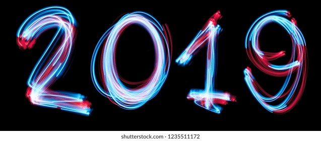 2019 happy new year number with neon lights backgrorund. blue light image, long exposure with colored fairy lights, against a black