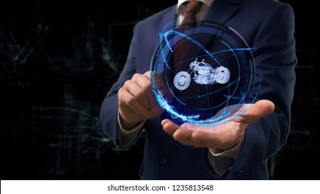 Businessman shows concept hologram 3d moto on his hand. Man in business suit with future technology screen and modern cosmic background