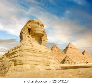 Famouse Sphinx and the great pyramids under interesting evening clouds, Cairo, Egypt