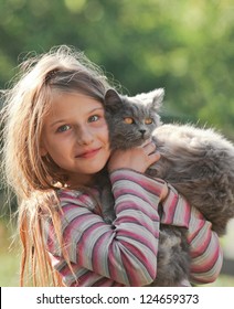 Happy child with cat. Kid showing