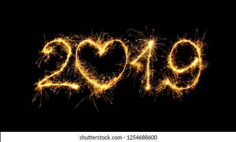 Happy New Year 2019. Number 2019 written sparkling sparklers isolated on black background for design. Beautiful Glowing overlay template for holiday greeting card.