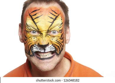 Man with face painting tiger smiling on white background