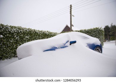 Snow storm covering a car