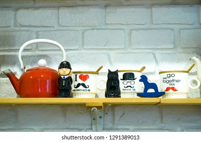 Police cartoon character, black cat, glass cup and red ceramic kettle Blue wooden horse placed on the floor