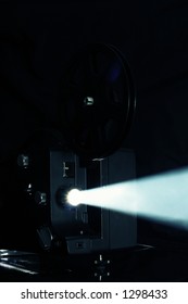 Film projector. Cinema projector light beam - ray of light Film reel on retro film projector.
