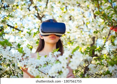 Gaming and entertainment. Virtual technology simulation. Young lady wear vr glasses in spring bloom. Cute girl play in spring garden. Pretty girl in virtual reality headset. Innovative vr technology.