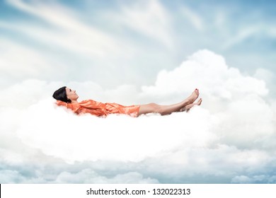 Beautiful girl, sleeping on a white cloud