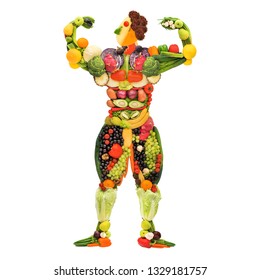 Creative diet food healthy eating concept photo of posing muscular bodybuilder made of fresh fruits and vegetables on white background.