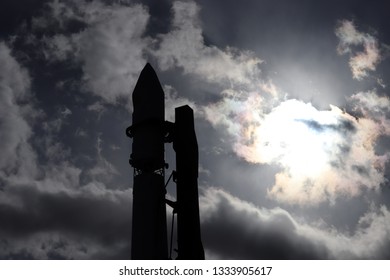 Space shuttle silhouette against the cloudy sky. Spaceship on the launch pad before starting, astronautics and cosmodrome concept