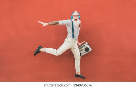 Senior gekke man springen en luisteren muziek buiten - Gelukkig volwassen mannetje vieren en dansen buiten - Joyful ouderen levensstijl concept - Focus op hem