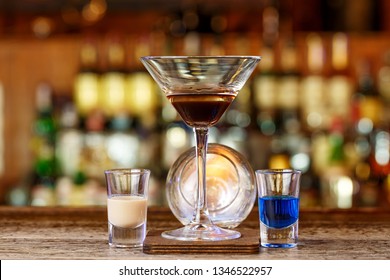 Club drink amborghini. Burning cocktail on the basis of sambuki and liqueurs, space for text, photo for the menu