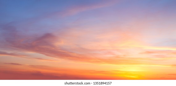 Real majestic sunrise sundown sky background with gentle colorful clouds without birds. Panoramic, big size