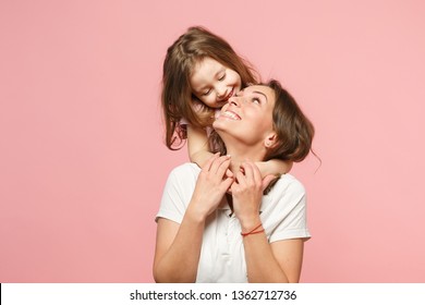 Woman in light clothes have fun with cute child baby girl. Mother, little kid daughter isolated on pastel pink wall background, studio portrait. Mother's Day love family, parenthood childhood concept