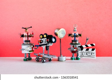 Funny robot cameraman and clapperboard assistant shoots dramatic comedy with elements of a horror movie and action adventure film. Motion picture robotic filmmaking backstage. The concept of automated