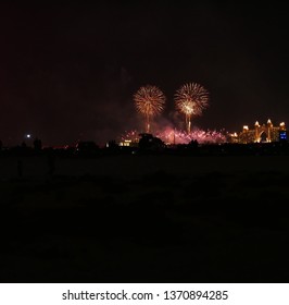 Fireworks stars over the bay with hotel in the background