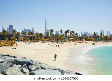 The beach of 'La Mer' (The Sea) with in the background the skyline of Dubai, United Arab Emirates