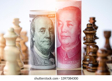 US dollar and Yuan banknote with chess for tariff trade war between United States and China which both countries battle by increase tax barrier of import and export product. Government and business.