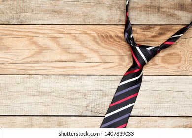 Krawatte auf hölzernem Hintergrund. Ansicht von oben. Vatertag.