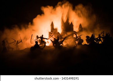 騎兵と歩兵による中世の戦闘シーン。個別のオブジェクトとしての人物のシルエットは、中世の城と暗いトーンの霧の背景に戦士の間で戦います。セレクティブ フォーカス