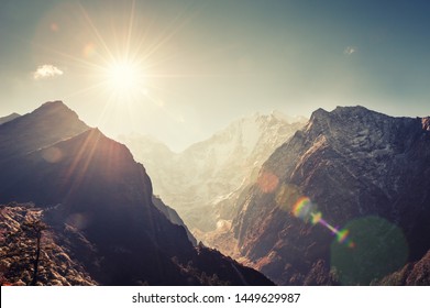 Himalaya mountains at sunrise. Lens flare effect. Khumbu valley, Everest region, Nepal. 