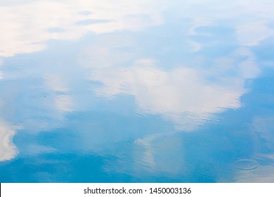 Blue sky and white cloud reflect on the water in a bright day look like impressionist painting, Water reflection abstract background concept
