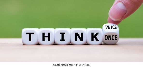Hand turns a dice and changes the expression "think once" to "think twice"