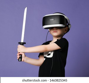 Young boy kid child play virtual reality game in vr glasses and explore alternative reality hold sword in hands. Cyber space and virtual gaming. Discover future technology on purple background banner