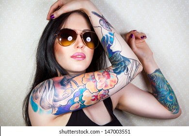 Portrait of a beautiful young woman with a tattoo
