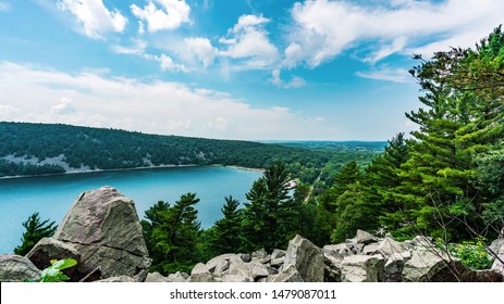 East Bluff trail in Devil's Lake State Park near Baraboo, Wisconsin, USA overlooking the majestic view of the serene body of water and rolling hills in the Midwest.