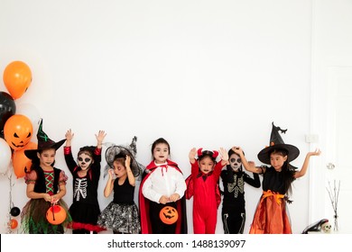 Happy Halloween, 5-8 years Cute asian little children with carving pumpkin preparing for Halloween. Funny kids at home.