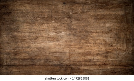 Textura de madera de color marrón oscuro con arañazos como fondo