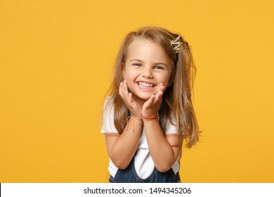 Little cute child kid baby girl 4-5 years old wears light denim clothes crown isolated on pastel yellow wall background children studio portrait. Mother's Day love family parenthood childhood concept