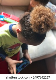 Red head mixed little boy playing cell phone video games