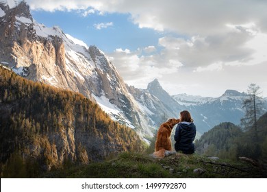 meisje met een toller hond in de bergen. Herfst stemming. Reizen met een huisdier. Nova Scotia Duck Tolling Retriever