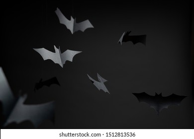 Image of gray paper bats on blank black background.