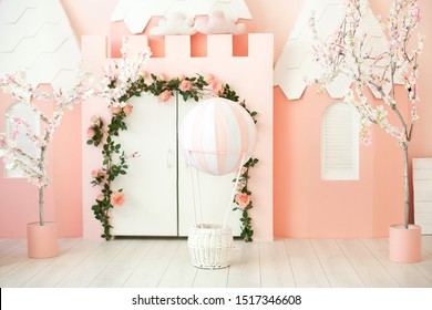 Playroom with pink castle tent for children. Children's room for a little princess. Decorations for a children's party. A room with tent, white door and balloon. Kindergarten, games room. interior