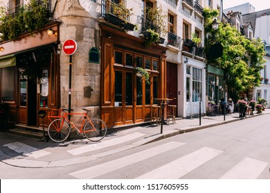 Cozy street with tables of cafe  in Paris, France. Architecture and landmarks of Paris. Postcard of Paris