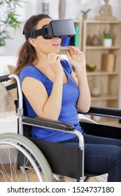 woman in wheelchair playing video games at home
