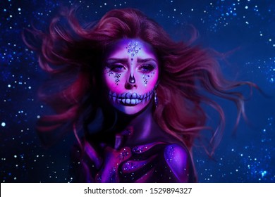 Portrait charming young woman with cute pink face red hair flying from wind poses in the purple neon light, image of skeleton using body art, dead princess. Celebrate Dia de los Muertos. Parade legend