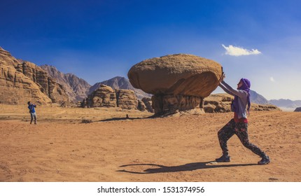 mainstream touristic photography with game of perspective and natural rocky architecture shapes in Wadi Rum Jordan Middle East desert picturesque scenic view beautiful travel destination place