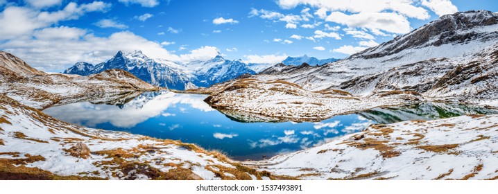 Banner of Bachalpsee lake in highlands of Grindelwald village in Switzerland. Winter scene. Panoramic view of iconic Swiss mountain lake - Bachalp. Popular trekking spot, view on Matterhorn peak.